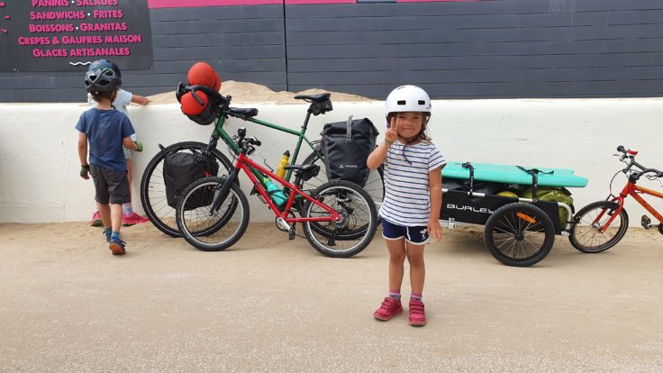Kinder mit Fahrrad und Anhänger